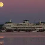Full Harvest Moon rises over a ferry in Kitsap County