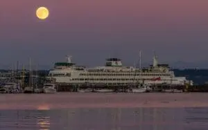 Full Harvest Moon rises over a ferry in Kitsap County