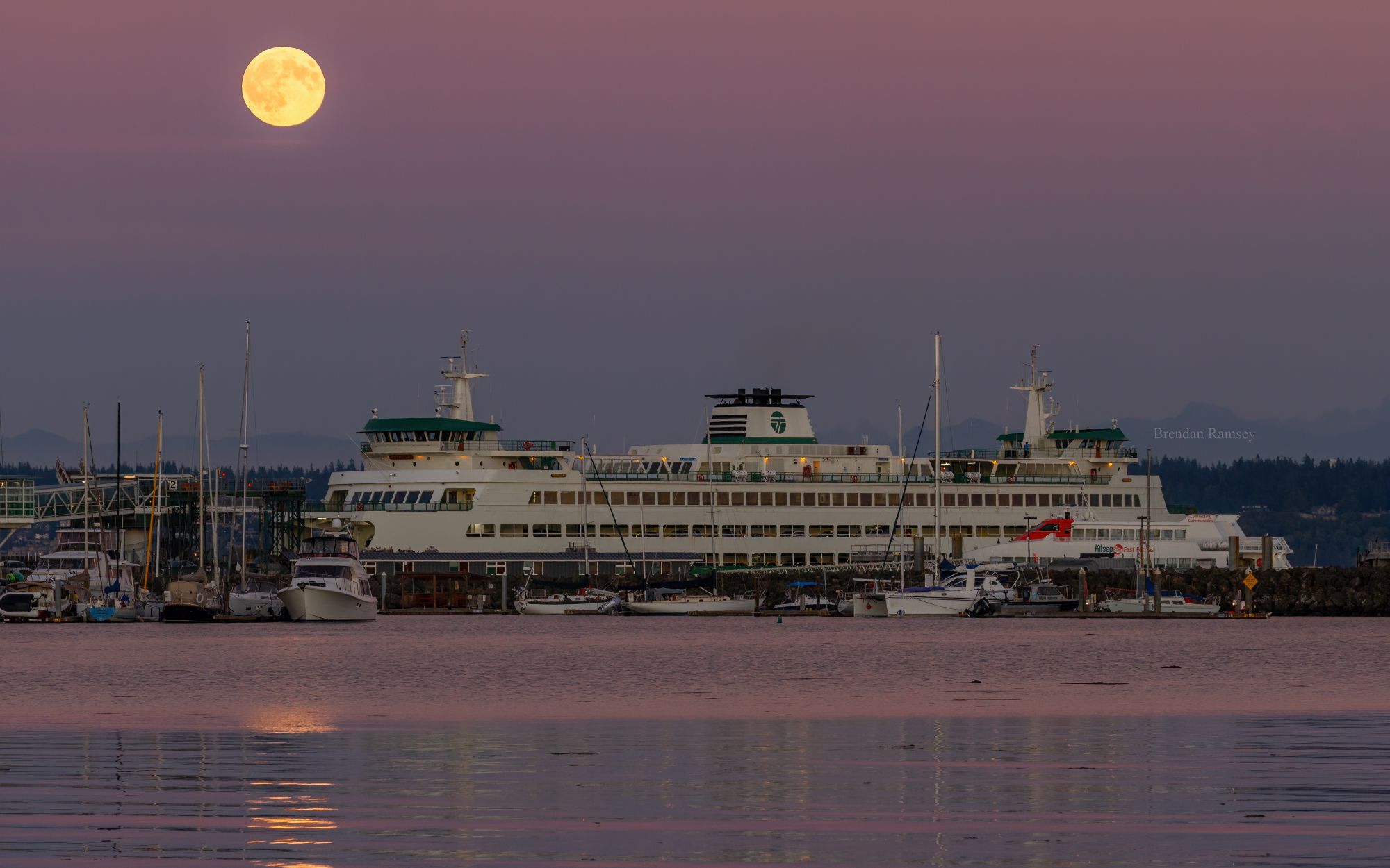 Full Harvest Moon rises over a ferry in Kitsap County